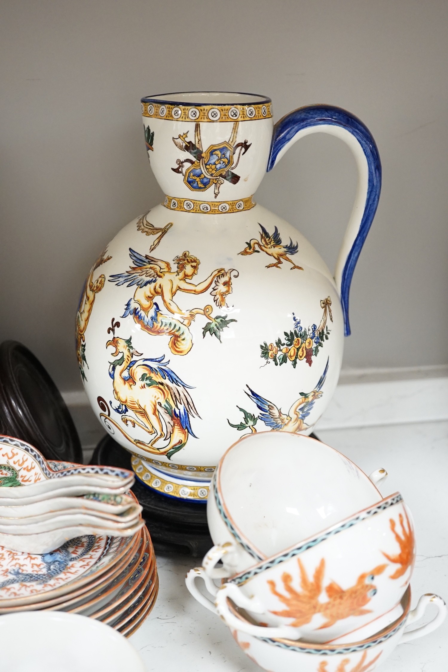 A Gien pottery jug, a Chinese crackle glaze baluster vase, egg-shell tableware and three Oriental wood stands